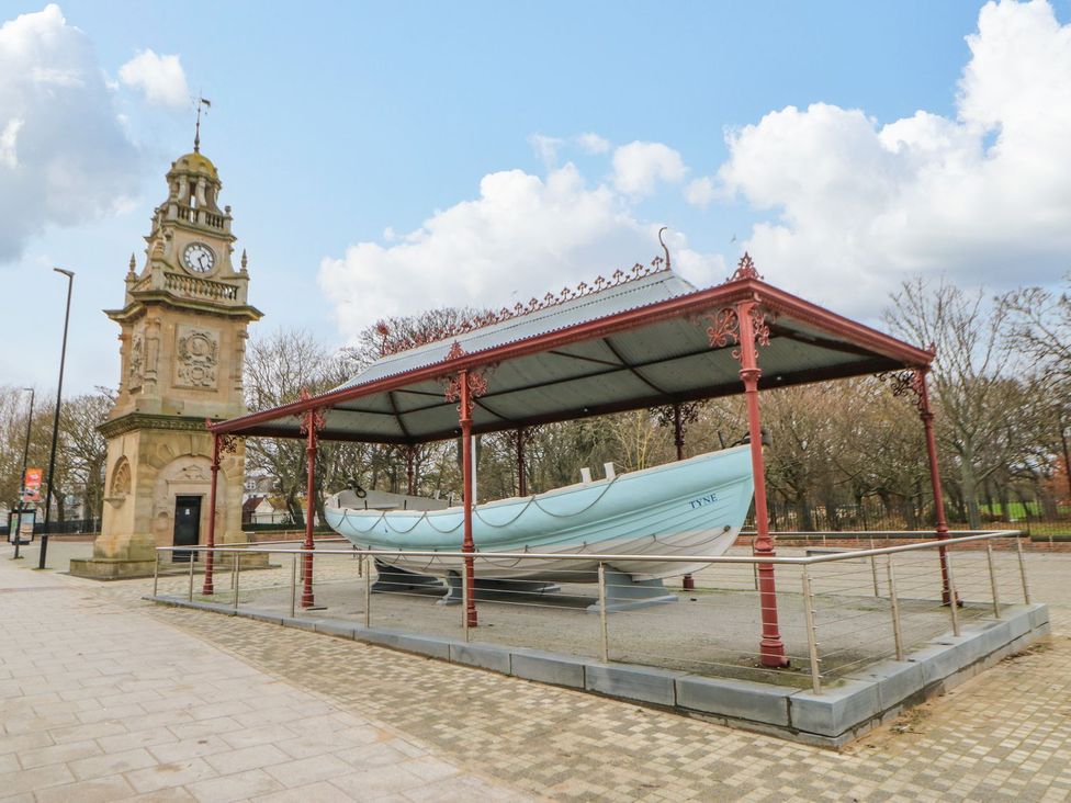 A clock tower and a boat under a canopy in a plaza at 16 Seafield Terrace in South Shields