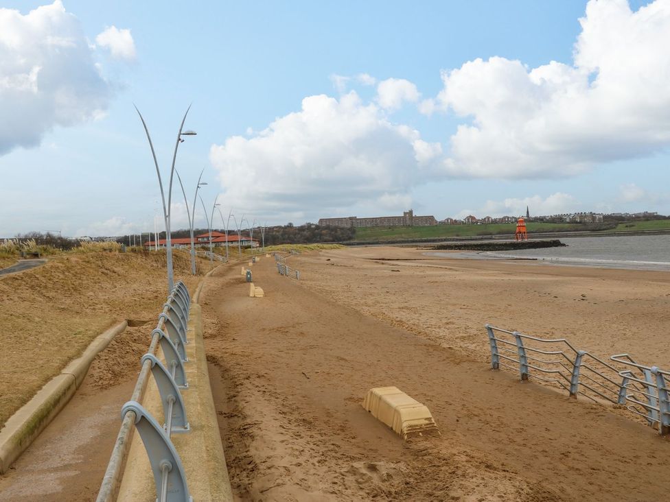 A beach with a fence and lamp posts at 16 Seafield Terrace South Shields