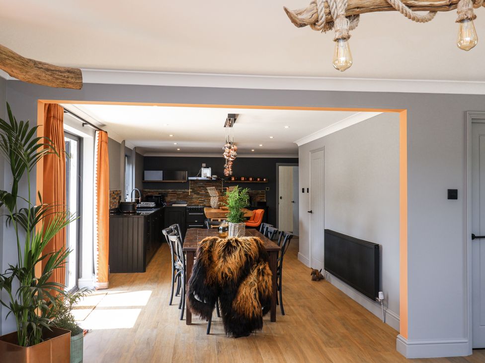 A dining room with a table and chairs at Holly Farm and Annexe near Brantham