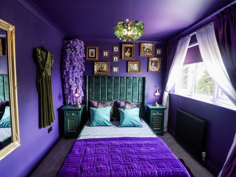 A bedroom with a bed and bedside table at Holly Farm near Brantham