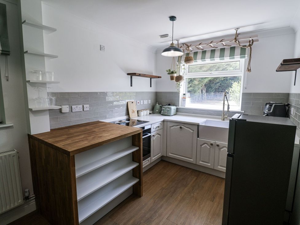 A kitchen with a sink and cooking appliances at Holly Farm near Brantham