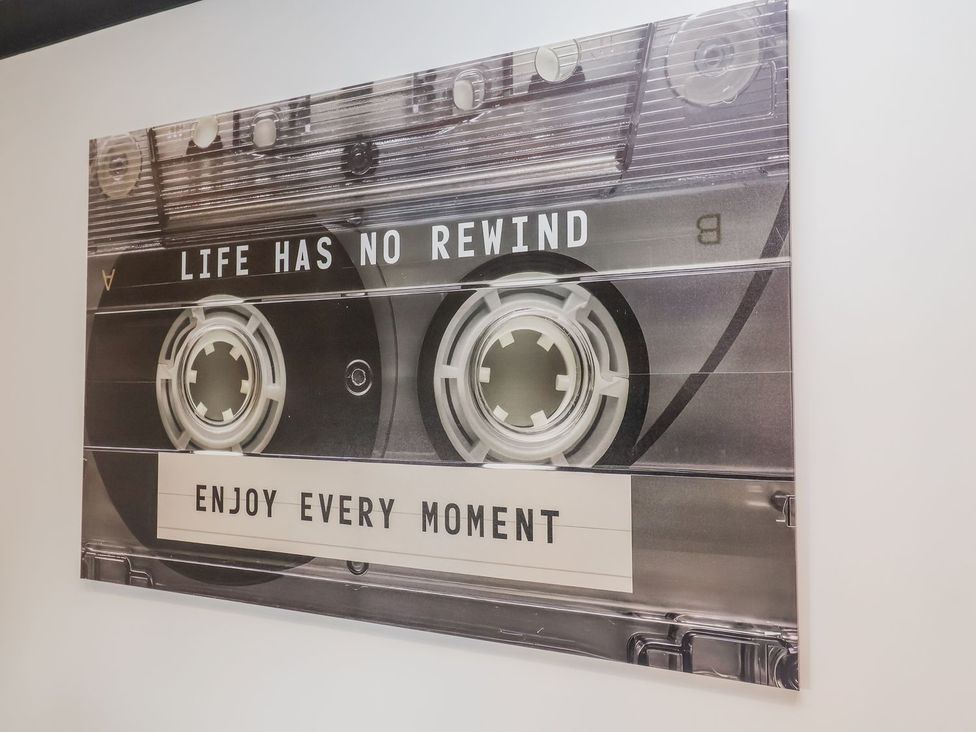 A wall art piece featuring a cassette tape design and motivational text at Holly Farm near Brantham