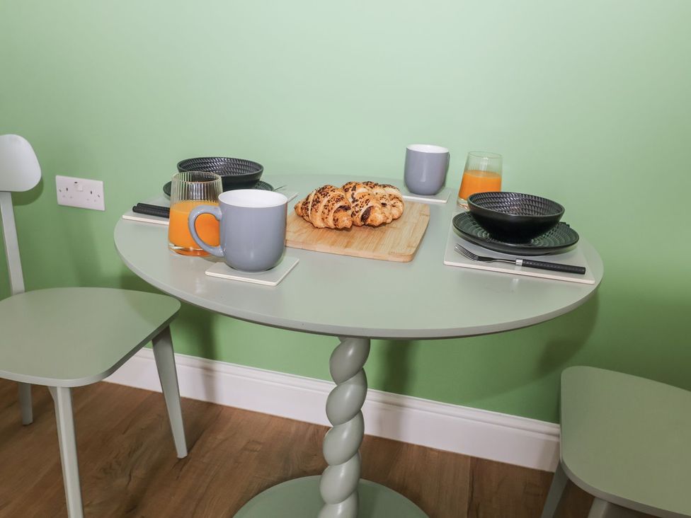 A dining table with croissants and drinks at Holly Farm near Brantham