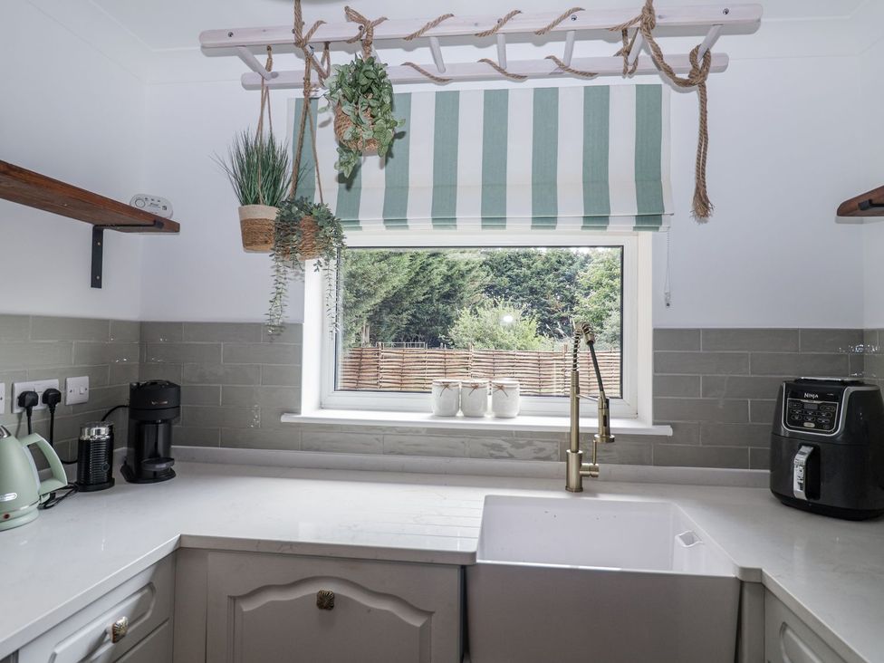 A kitchen with a sink and appliances at Holly Farm near Brantham