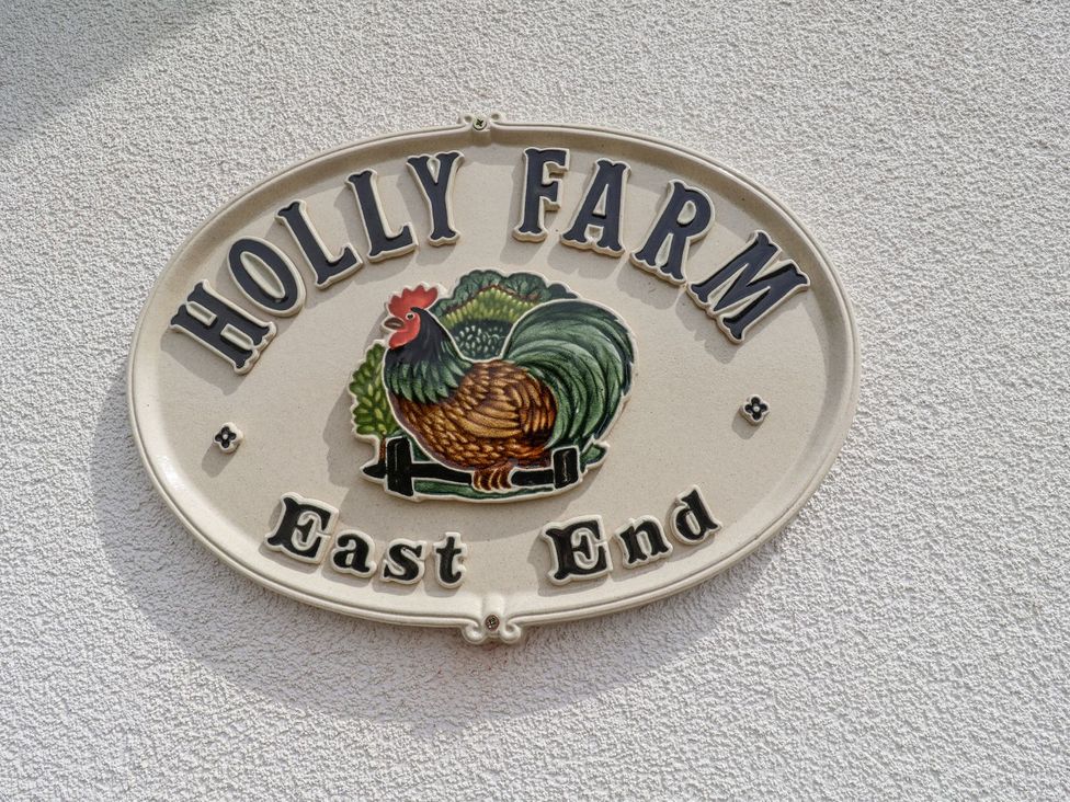 A sign displaying Holly Farm and East End at Holly Farm near Brantham
