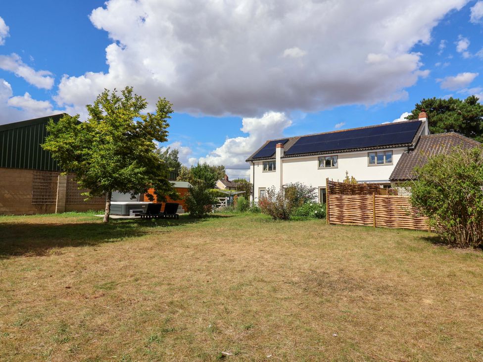 An outdoor area with a house and a tree at Holly Farm near Brantham