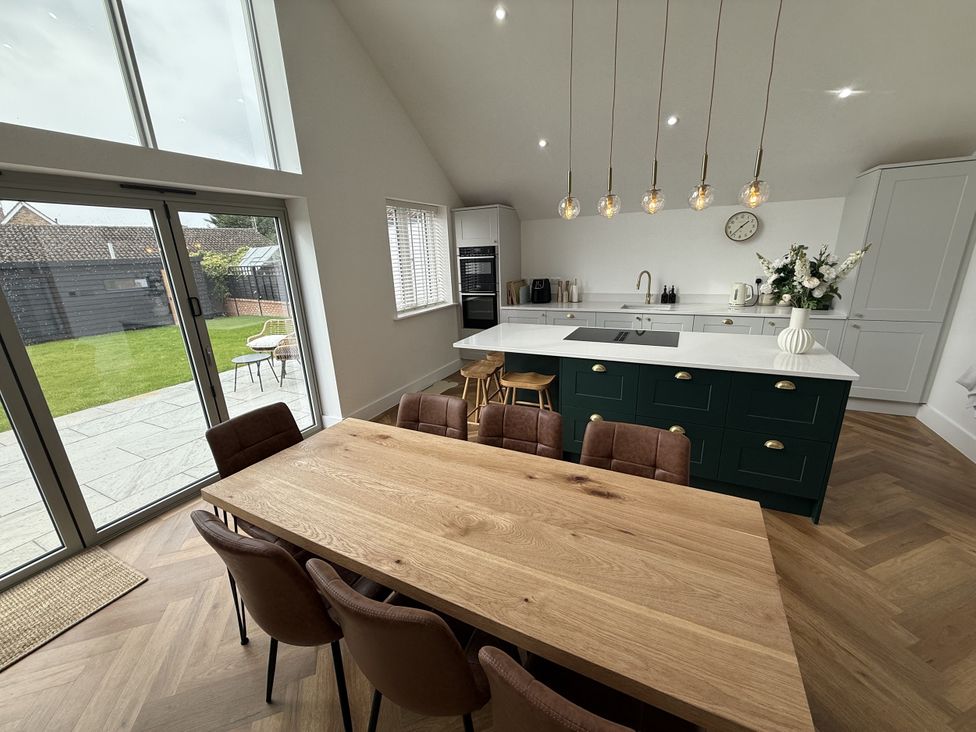 A kitchen with a large table and chairs at Bader House in Ipswich