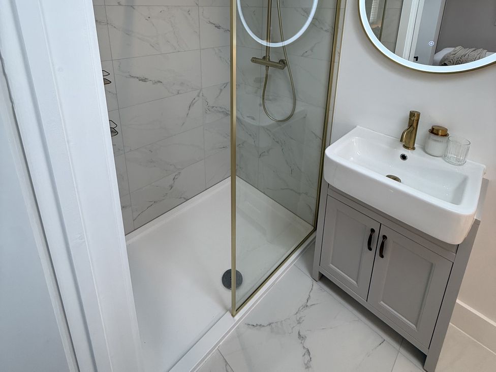 A shower and sink in a bathroom at Bader House Ipswich