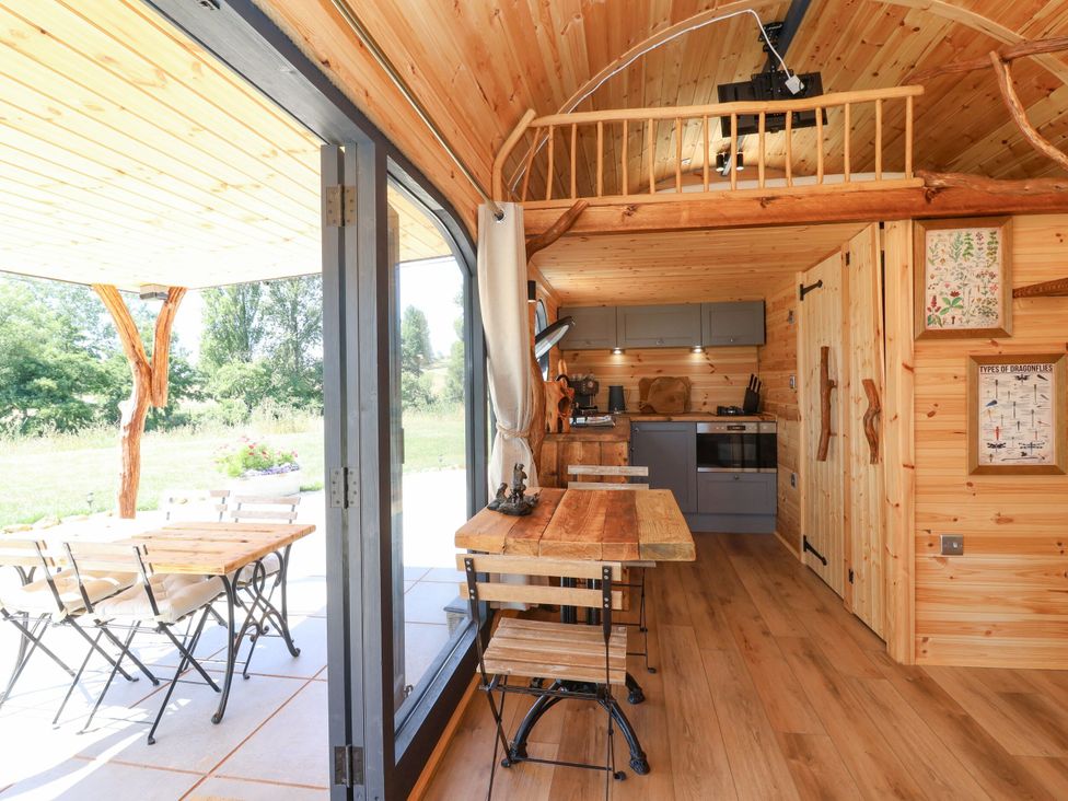 A kitchen with a table and chairs at Bugley Pools Hideaway Bugley near Gillingham