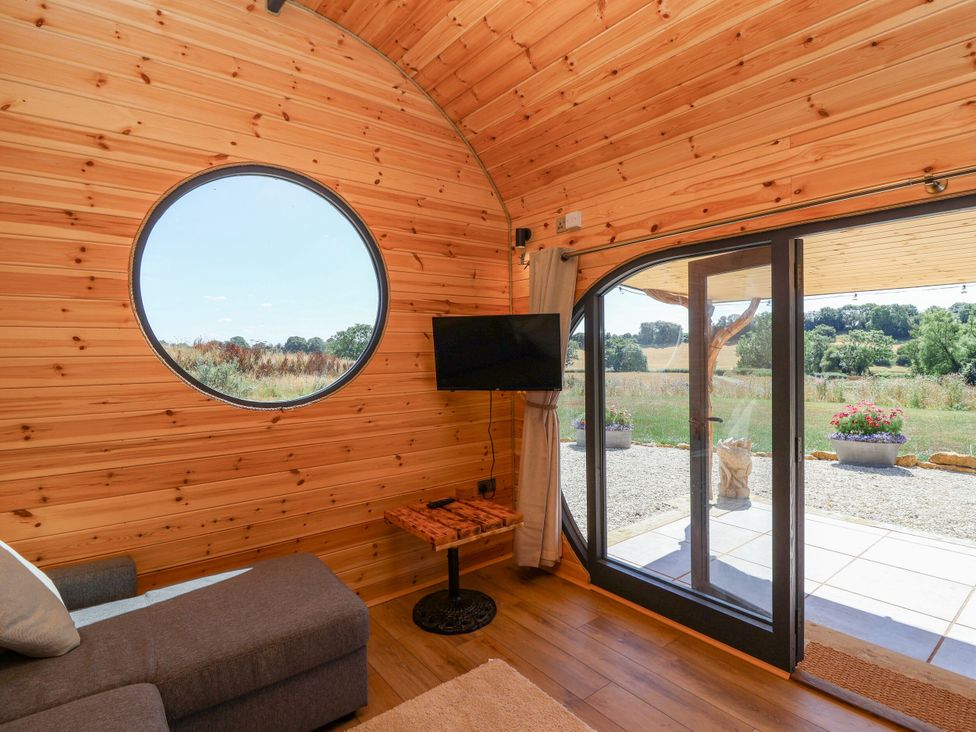 A living room with a sofa and television at Bugley Pools Hideaway in Bugley near Gillingham