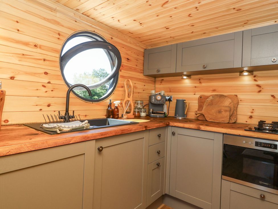 A kitchen with a sink and coffee maker at Bugley Pools Hideaway in Bugley near Gillingham