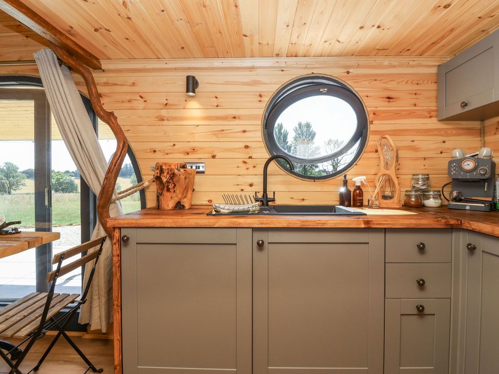 A kitchen with a sink and wooden countertop at Bugley Pools Hideaway Bugley near Gillingham