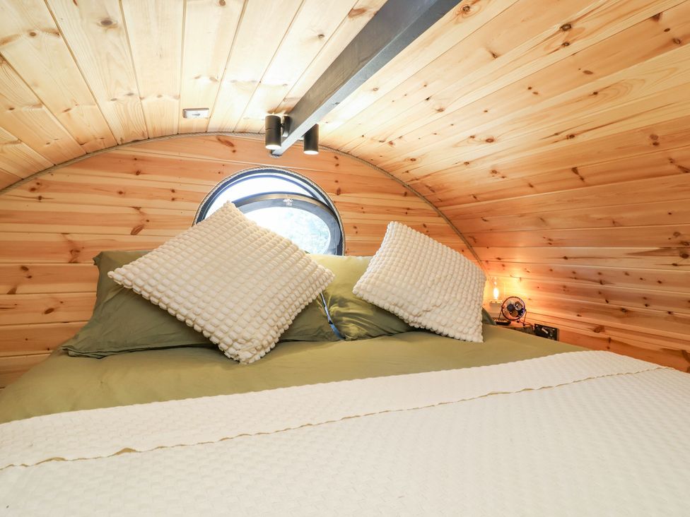 A bedroom with a bed and pillows at Bugley Pools Hideaway in Bugley near Gillingham