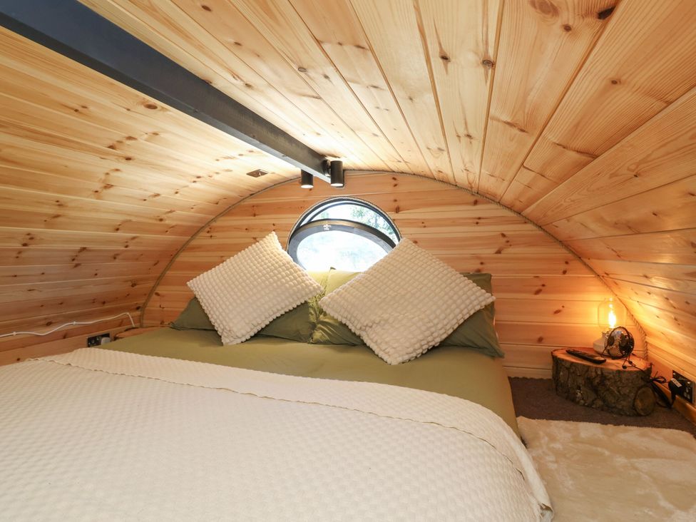 A bedroom with a bed and pillows at Bugley Pools Hideaway in Bugley near Gillingham