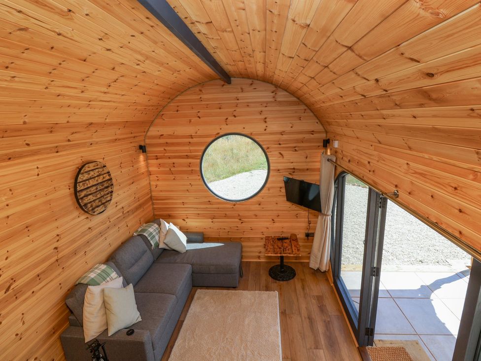 A living room with a couch and coffee table at Bugley Pools Hideaway in Bugley near Gillingham
