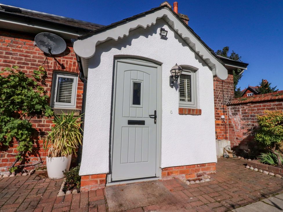A front entryway with a gray door and plants at Cottage in 