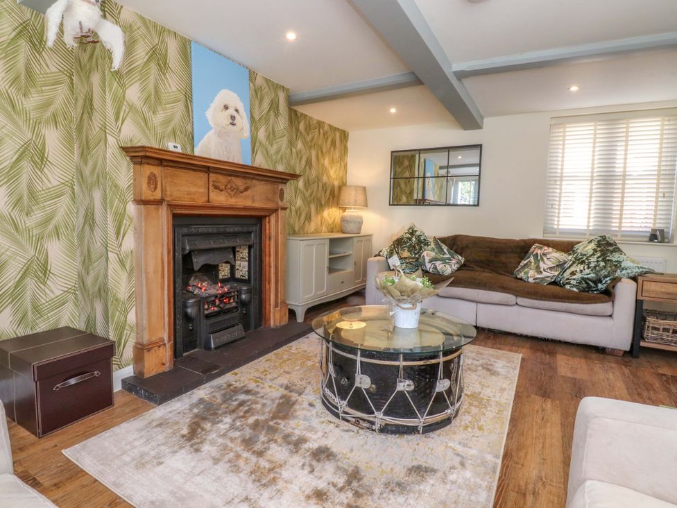 A living room with a fireplace and couch at Cottage