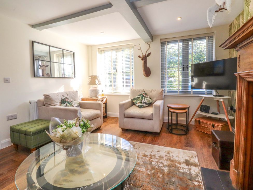 A living room with a sofa and armchair at Cottage in 