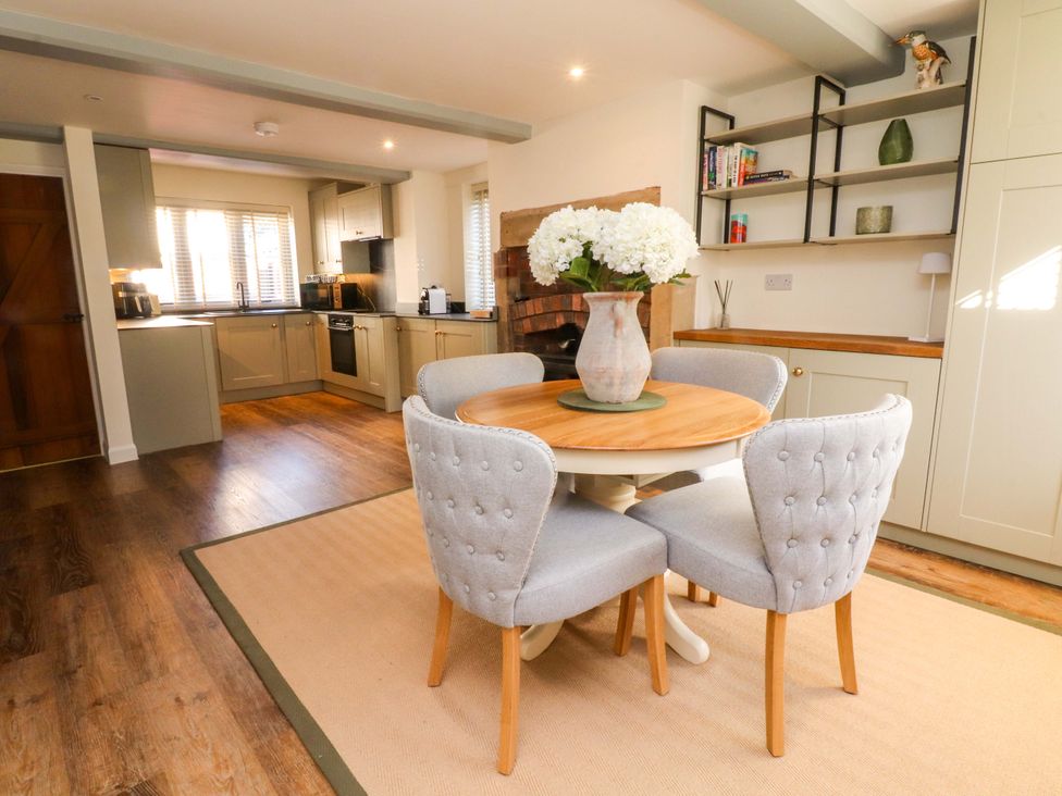 A dining area with a table and chairs at Cottage in 