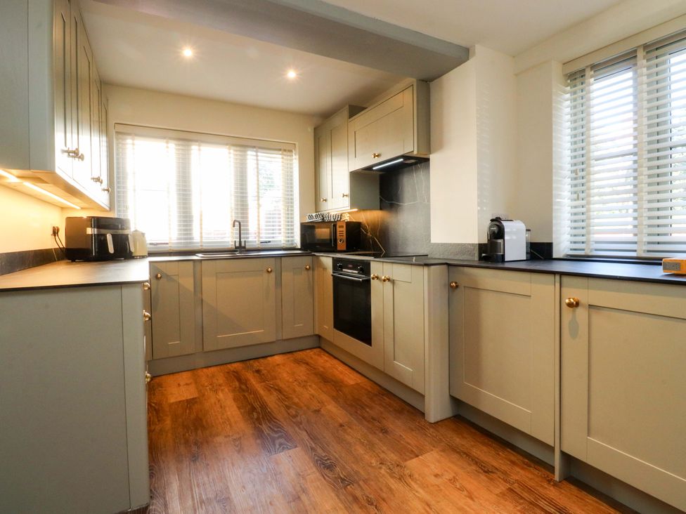 A kitchen with cabinets and appliances at Cottage