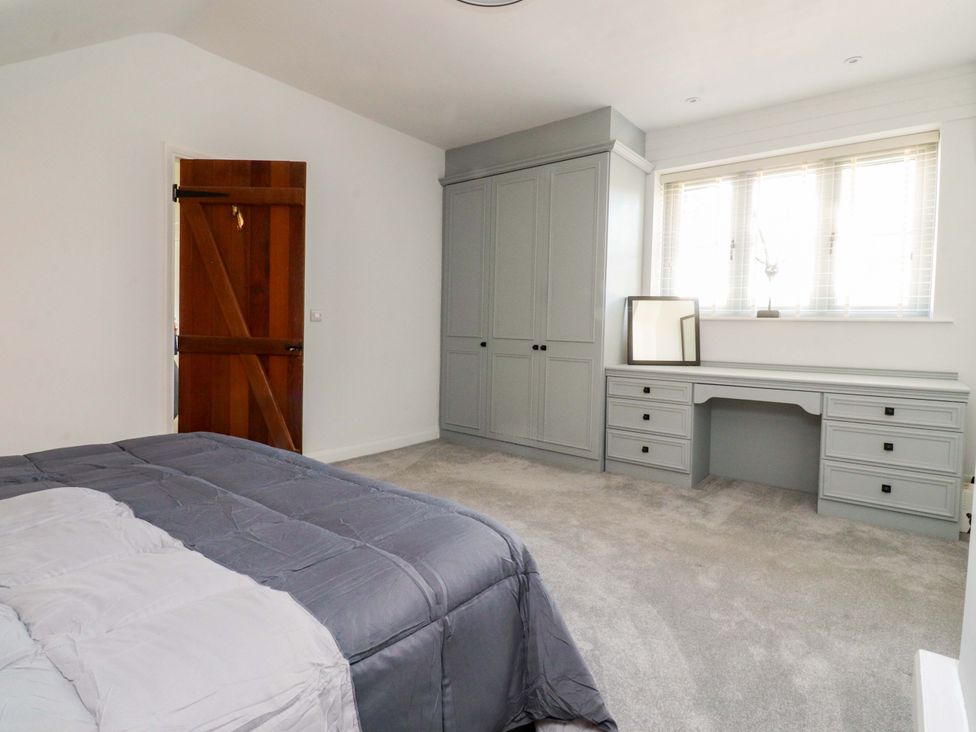 A bedroom with a bed and desk at Cottage in 