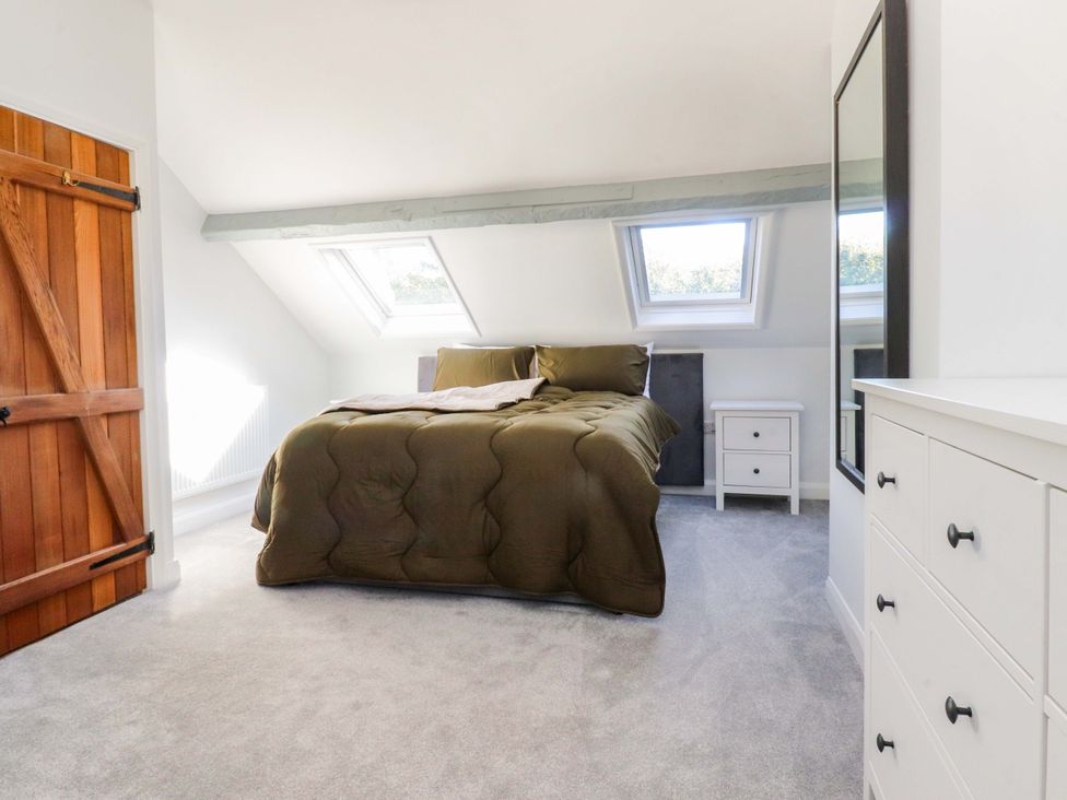 A bedroom with a bed and a skylight at Cottage in 