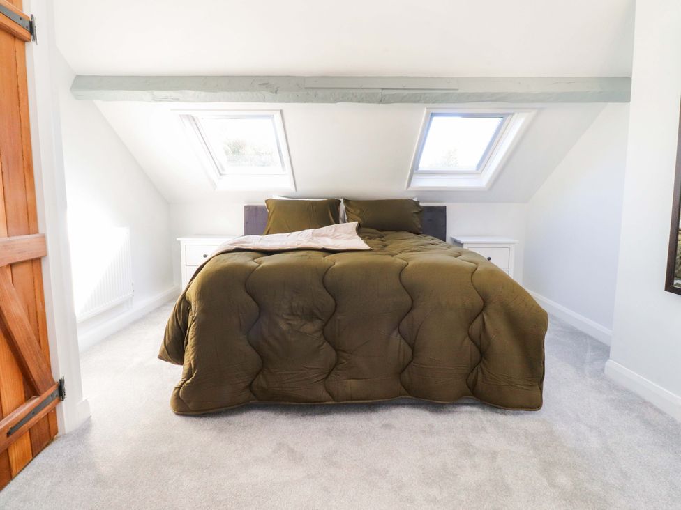 A bedroom with a bed and skylights at Cottage in 