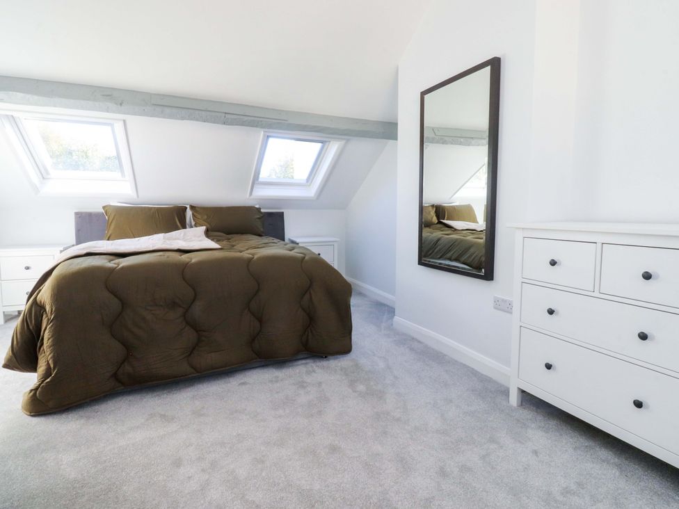 A bedroom with a bed and side tables at Cottage in 