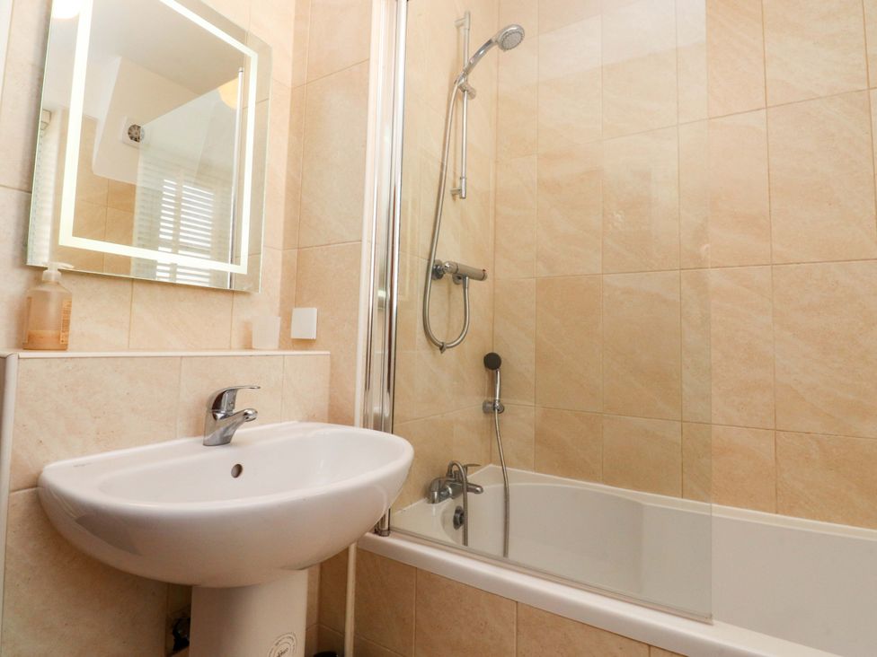 A bathroom featuring a sink, shower, and bathtub