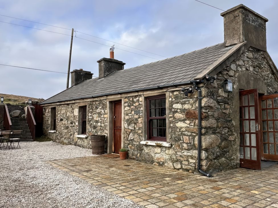 A stone cottage with paved area and steps at Cobble Stone Cottage near Leabgarrow, County Donegal