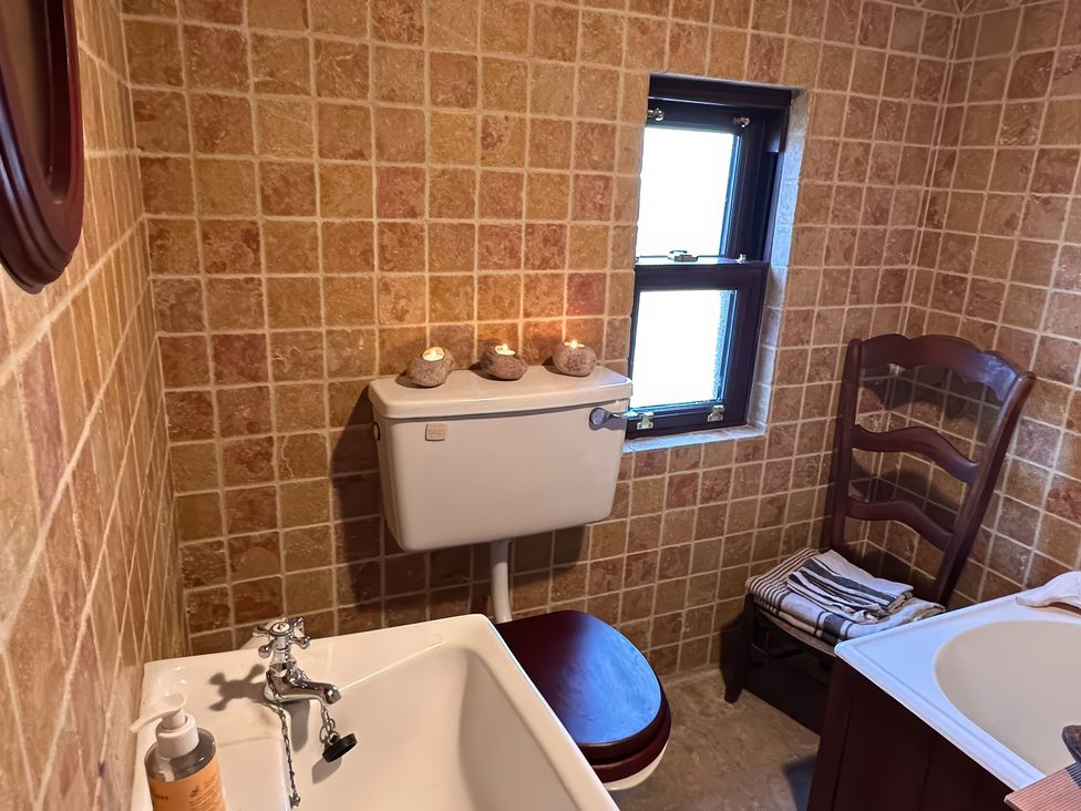 A bathroom with a sink, bathtub and toilet at Cobble Stone Cottage near Leabgarrow, County Donegal