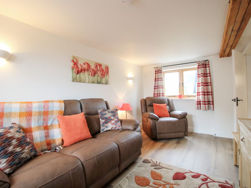 A living room with a sofa and recliner at Ash Barn in Northwood near Wem
