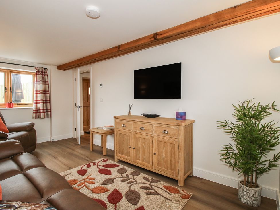 A living room with a television and sofa at Ash Barn Northwood near Wem