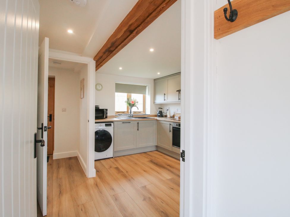 A kitchen with appliances and a window at Ash Barn near Wem