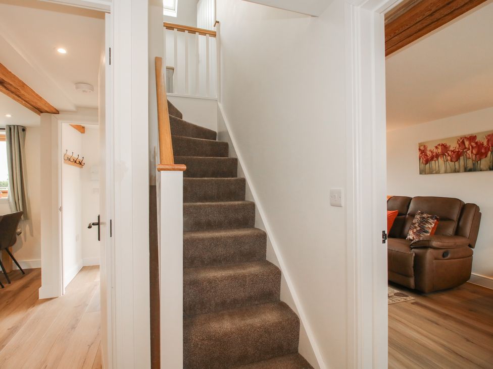 A staircase with carpet and handrail at Ash Barn Northwood near Wem