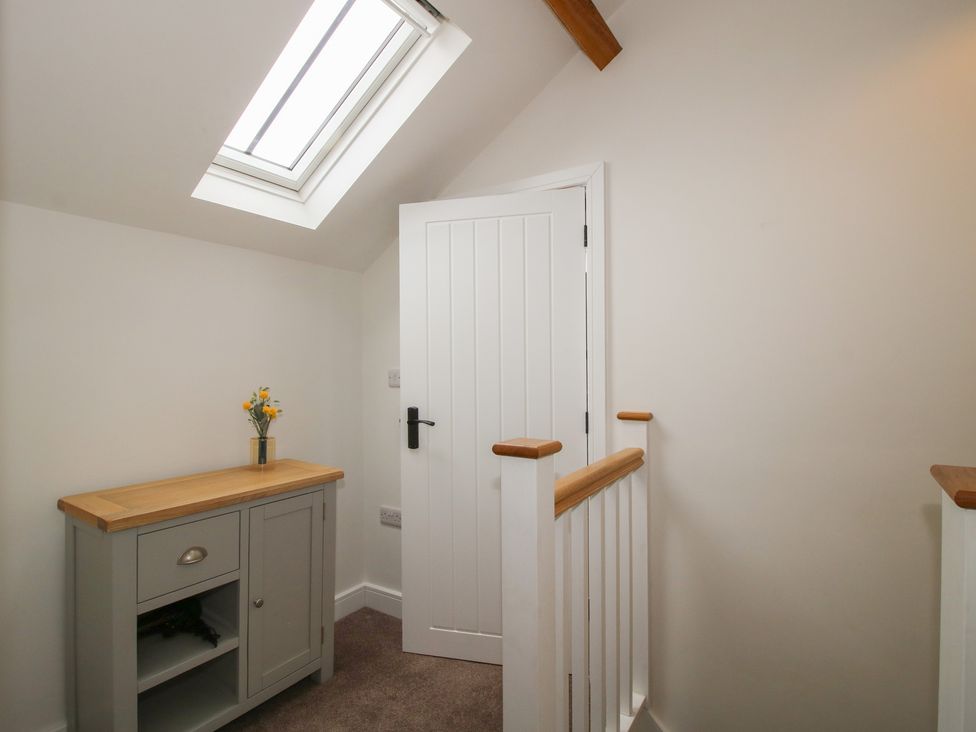 A hallway with a table and flowers at Ash Barn in Northwood near Wem