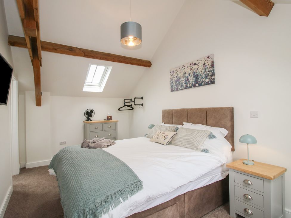 A bedroom with a bed and bedside table at Ash Barn Northwood near Wem