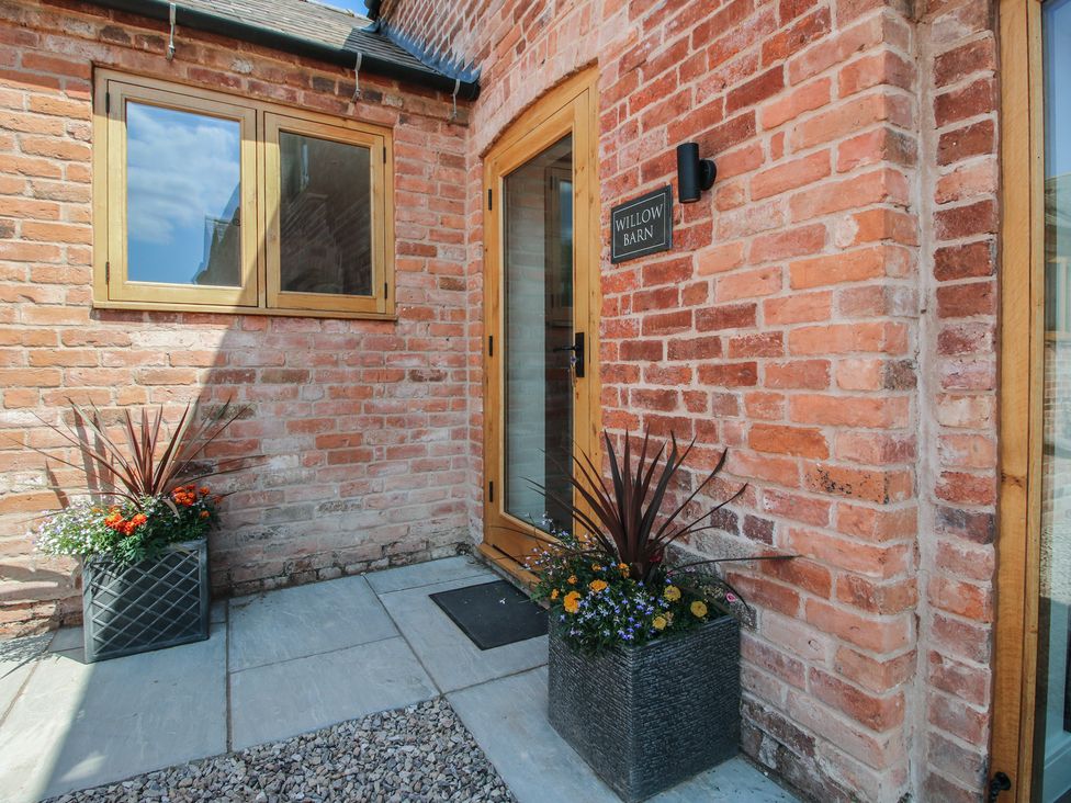 An entrance with a door and plants at Willow Barn in Shrewsbury