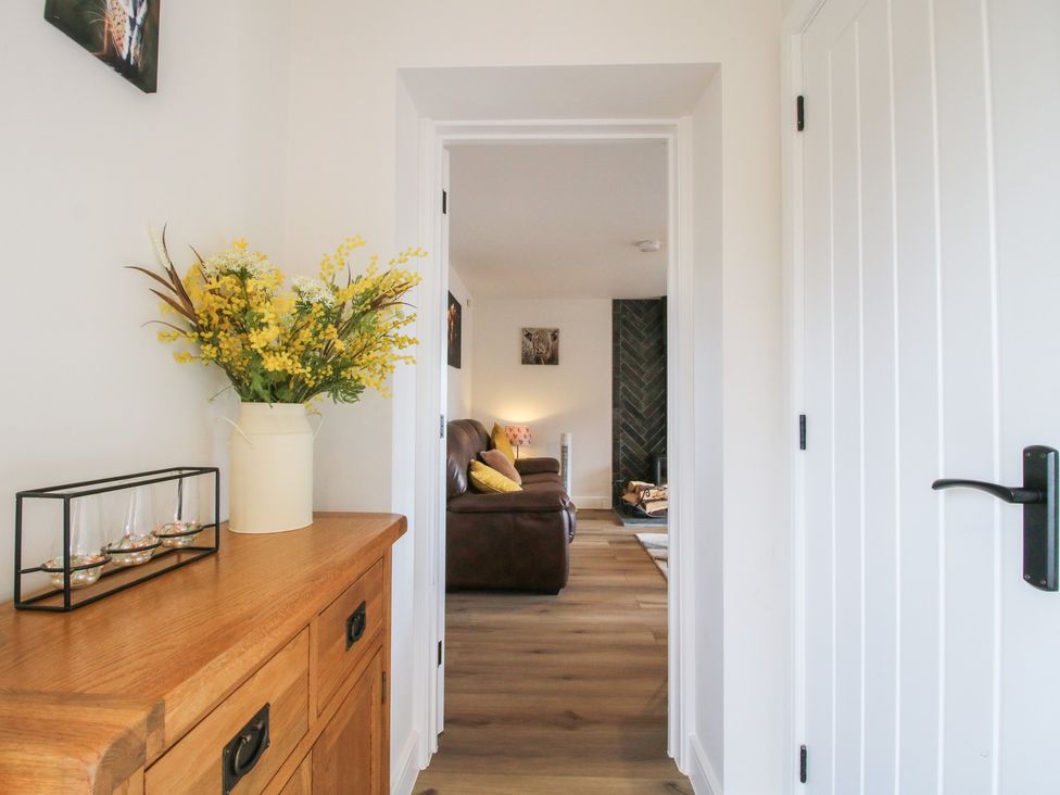 A hallway with a console table and flowers at Willow Barn Northwood near Wem