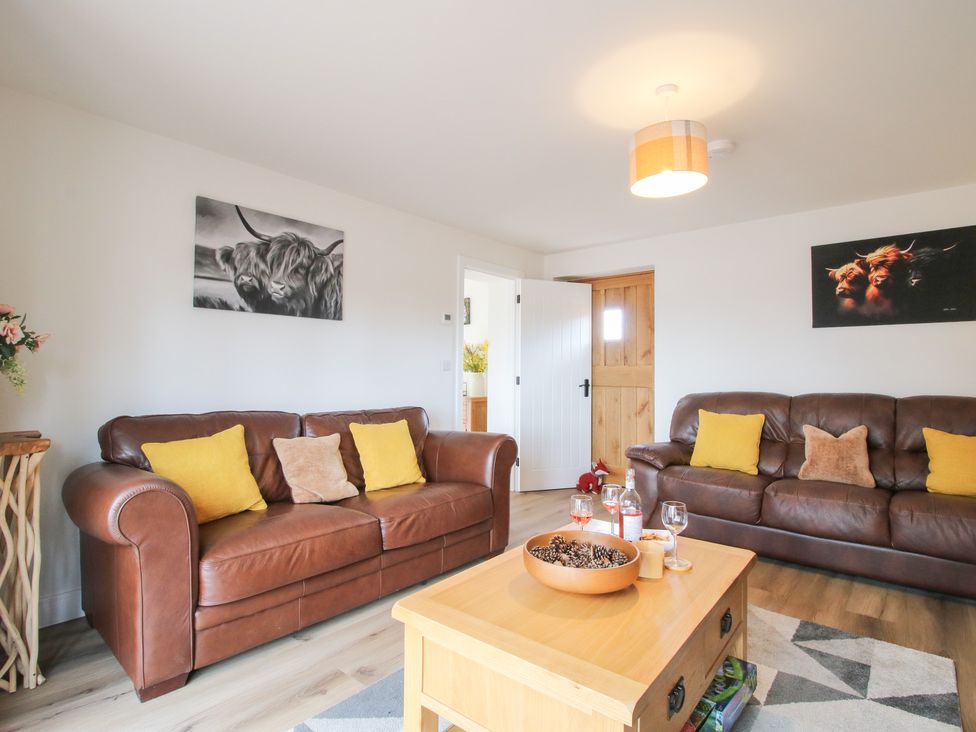 A living room with sofas and a coffee table at Willow Barn near Wem