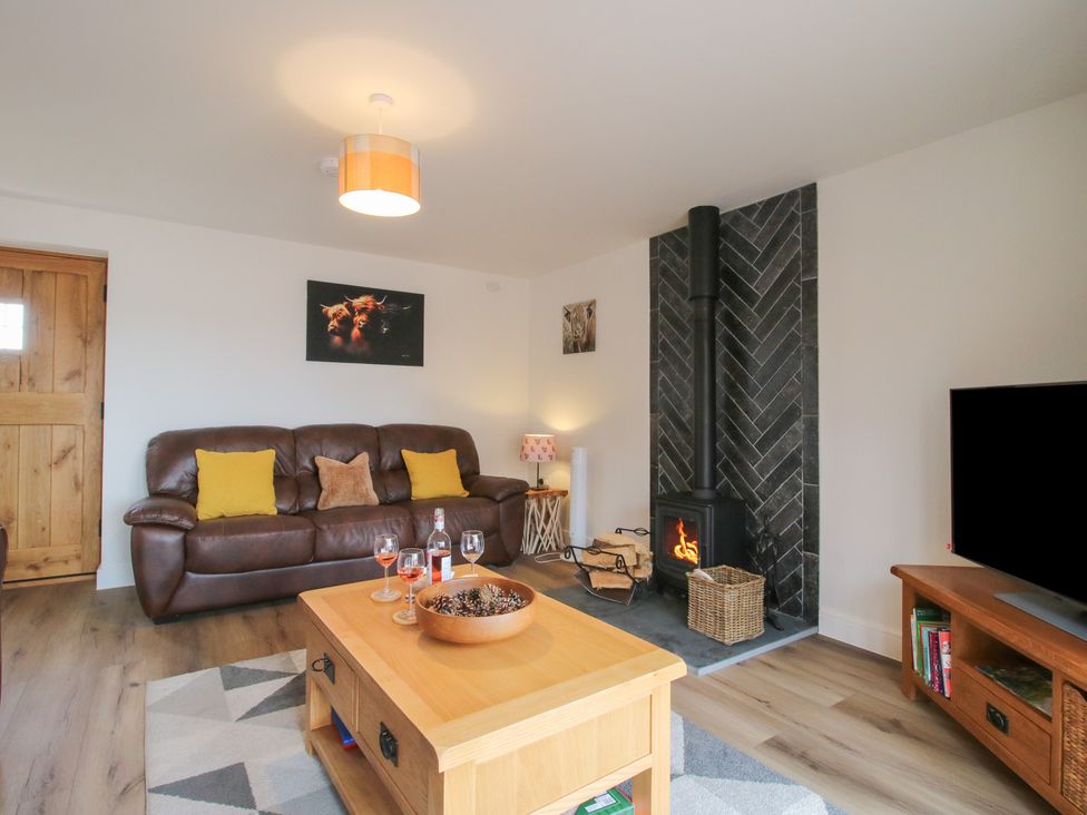 A living room with a sofa and fireplace at Willow Barn Northwood near Wem