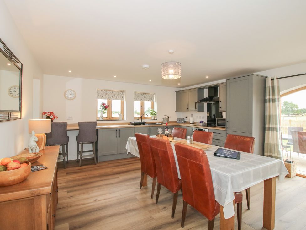 A dining room with a table and chairs at Willow Barn Northwood near Wem