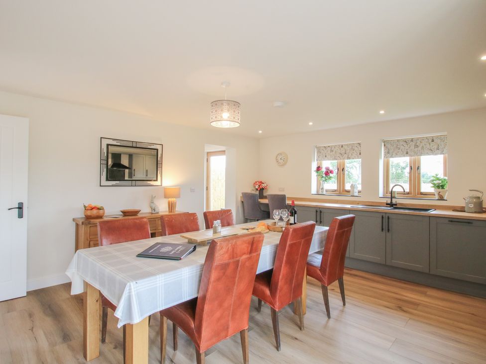 A dining room with a table and chairs at Willow Barn in Northwood near Wem