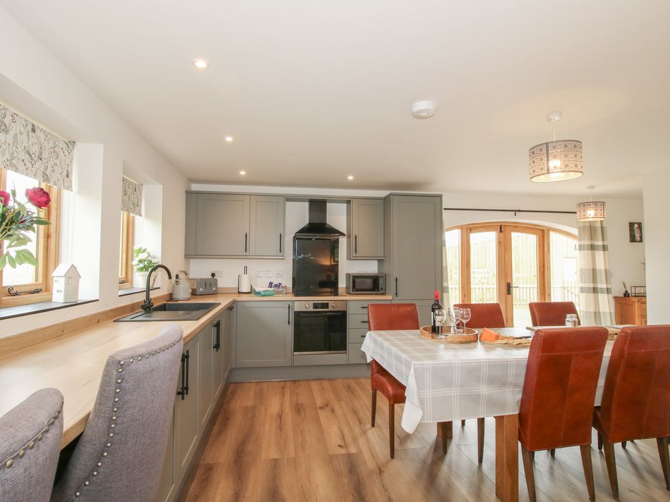 A kitchen with a dining table and chairs at Willow Barn Northwood near Wem