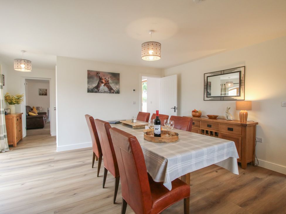 A dining room with a table set for dinner at Willow Barn Northwood near Wem