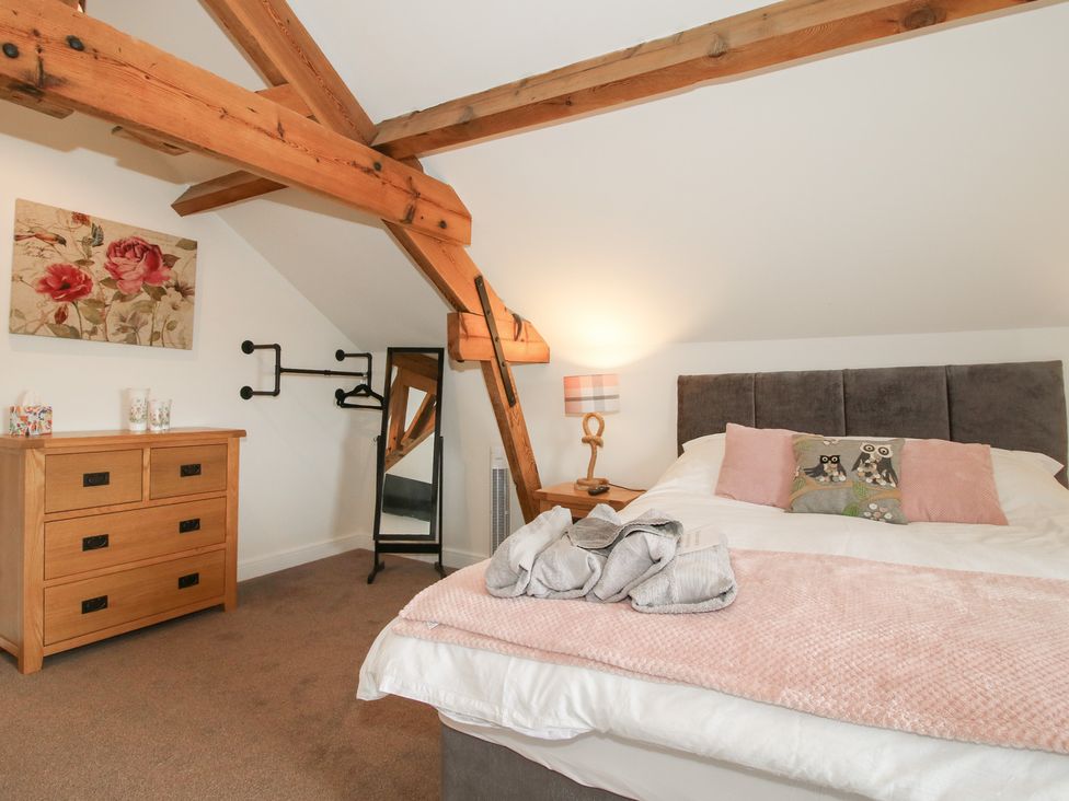 A bedroom with a bed, dresser, and mirror at Willow Barn Northwood near Wem