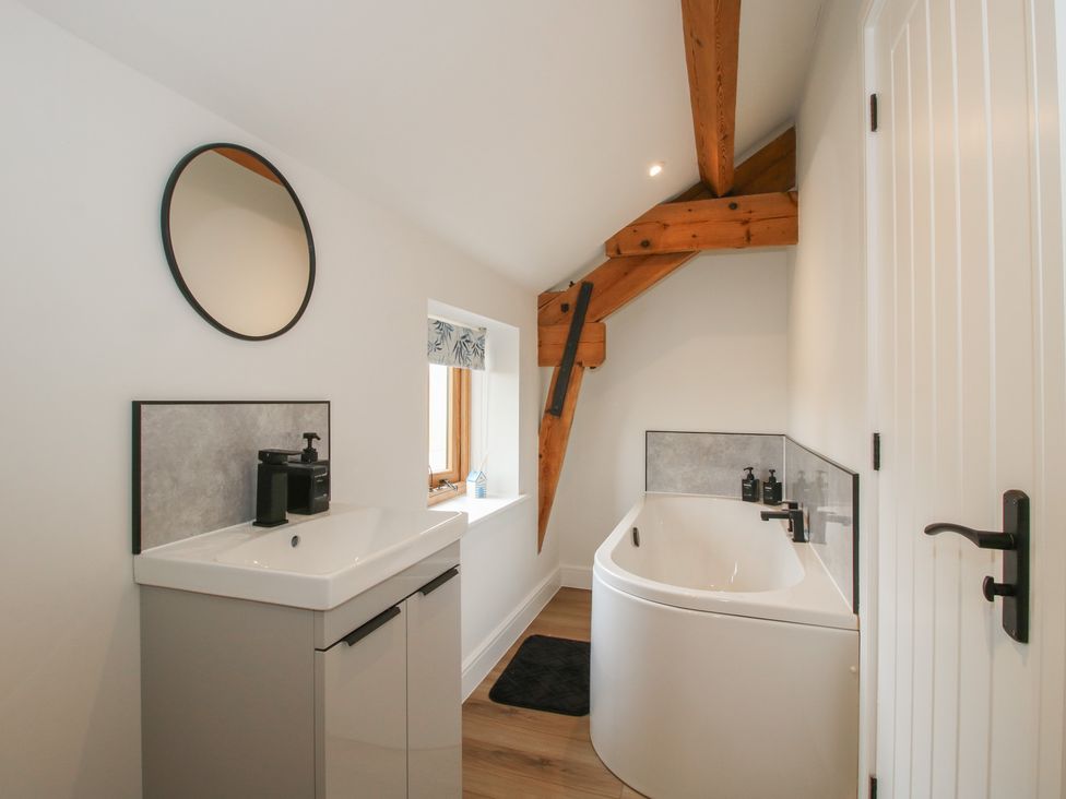 A bathroom with a sink and bath tub at Willow Barn Northwood near Wem