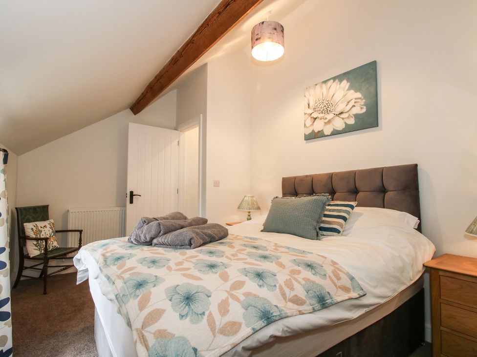 A bedroom with a bed and lamps at Willow Barn in Northwood near Wem