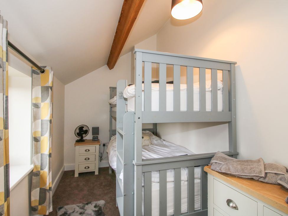 A bedroom with a bunk bed and nightstand at Willow Barn Northwood near Wem