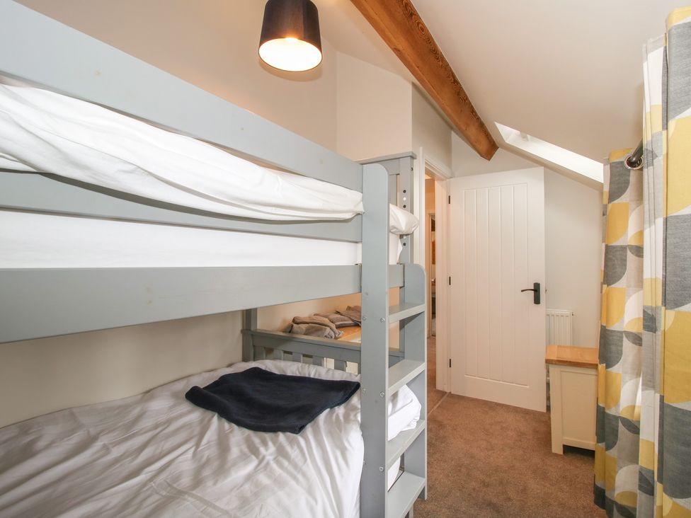 A bedroom with a bunk bed and a door at Willow Barn Northwood near Wem